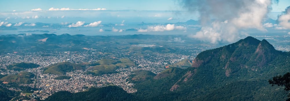 Stunning aerial view of Rio de Janeiro Bay, with the cityscape and mountains in the background, on a sunny summer day.