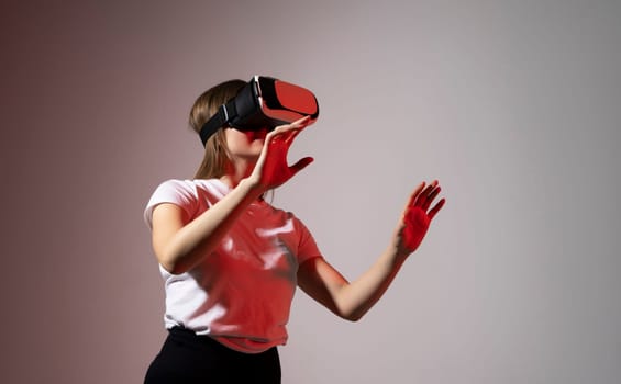 Woman enjoying a VR experience. Woman with VR headset touching invisible screen. Future technology concept