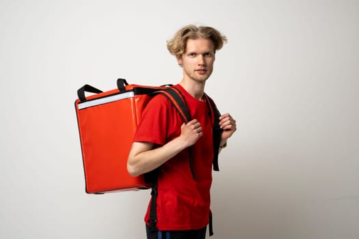 Young courier with thermo bag on white background. Food delivery service