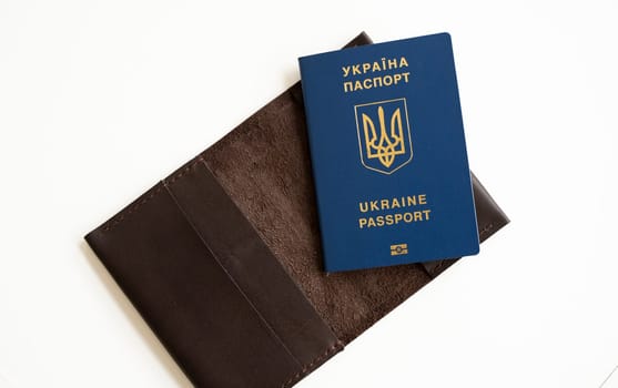 Ukrainian passport with a leather cover on a white background, selective focus. Inscription in Ukrainian Ukraine Passport