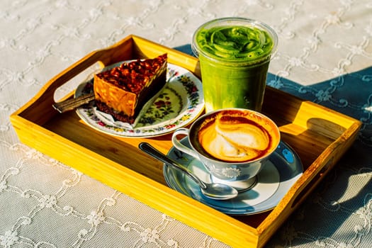 cake with hot coffee and Green tea Latte on linen cover table