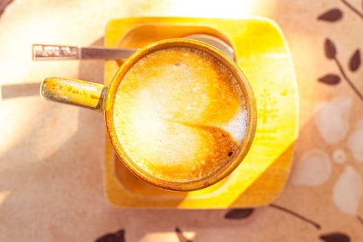 coffee, books on table in summer garden. Rest in garden, reading books, breakfast, vacations in nature concept. Summertime in garden on backyard