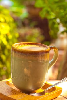 coffee, books on table in summer garden. Rest in garden, reading books, breakfast, vacations in nature concept. Summertime in garden on backyard