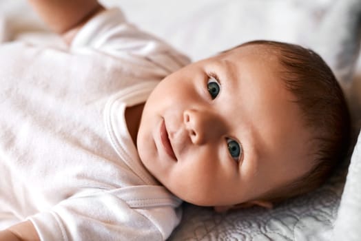 Meet Mr Adorable. an adorable baby boy lying down on a bed at home