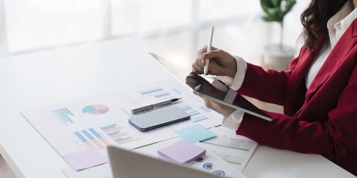 Young business woman holding stylus pen with digital tablet screen. business financial concept.