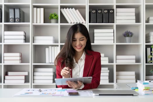 Young business woman holding stylus pen with digital tablet screen. business financial concept.