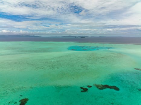 Top view of lagoon surface on atoll and coral reef, copy space for text. Balabac, Palawan. Philippines.