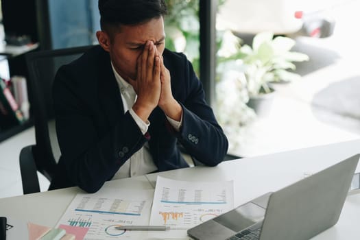 Portrait of business owner, man using computer and financial statements Anxious expression on expanding the market to increase the ability to invest in business