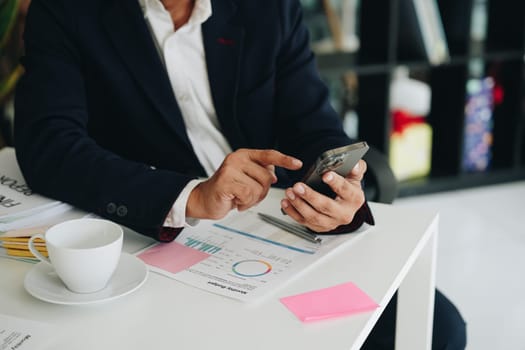 business owner or Asian male marketers are using business phones in office work.