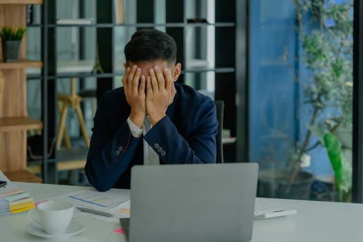 Portrait of business owner, man using computer and financial statements Anxious expression on expanding the market to increase the ability to invest in business