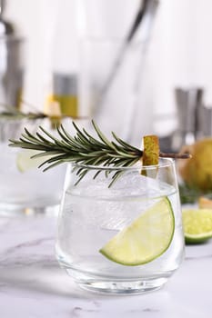 Gin Cocktail with lime, rosemary, ripe pear and tonic. This refreshing, organic drink is full of vibrant flavors and aromatic herbs.