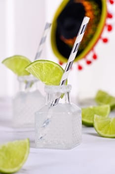 Classic alcoholic cocktail Margarita. Served in mini bottles with salt and lime. An original idea for a buffet event.