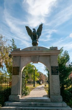 SAVANNAH, USA - DECEMBER 02, 2011: an arch with information signs at the entrance to an old cemetery in Savannah