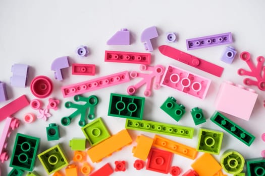 Multicolored plastic building blocks of the designer. Background of bright plastic building blocks.