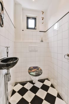 a black and white checkered floor in a bathroom with a toilet, sink and mirror on the left side