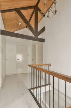 an empty room with white walls and wood beams on the ceiling there is a staircase leading up to the second floor