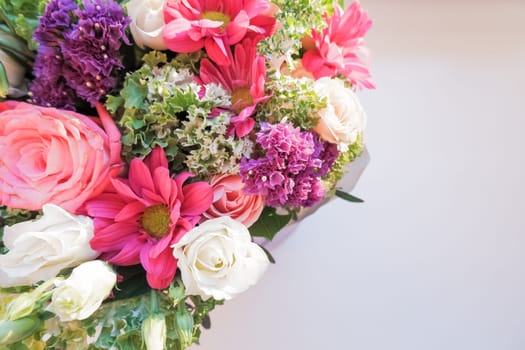 Elegant bouquet of amaryllis, chrysanthemums and roses on a white background. A large bouquet of exotic flowers.
