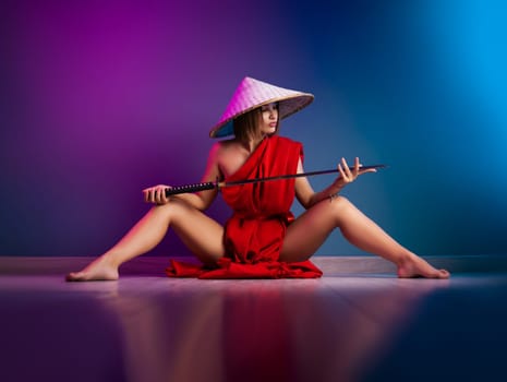 the sexy woman in a red cape and an Asian hat with a katana in her hand image of a samurai in neon color