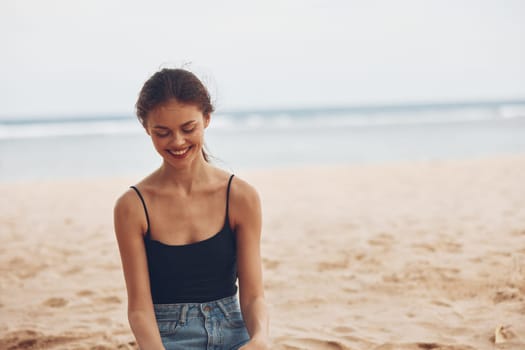 woman travel beautiful smile outdoor tropical water freedom vacation sand sea nature beach attractive sitting view ocean back holiday alone hair summer