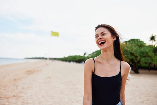 woman nature tropical free person summer sand girl smile vacation caucasian relax walk ocean sun sea coast female young beach copy-space