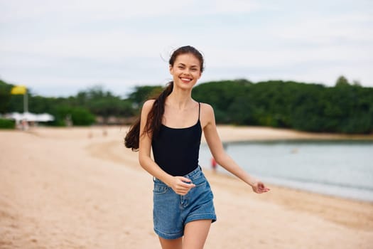 beach woman young summer leisure lifestyle travel freedom ocean smile sun sunset water active nature positive vacation running sea happy hair
