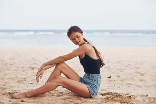 beautiful woman sand white freedom sea beach smile sitting model water alone ocean nature person coast pretty tan vacation travel girl