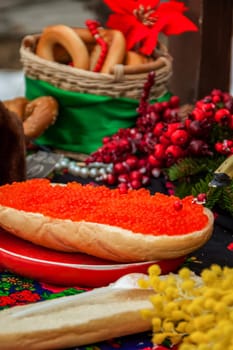 Red caviar is spread on bread with a thick layer. Maslenitsa street fair. Outdoor food