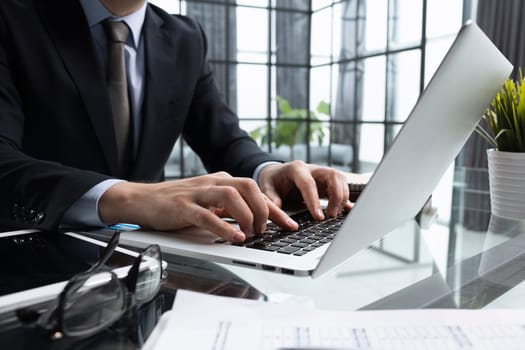 Close-up of male hands typing laptop keyboard. man using laptop