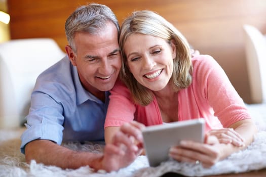 Technology brings them closer. a loving husband and wife using a digital tablet together at home