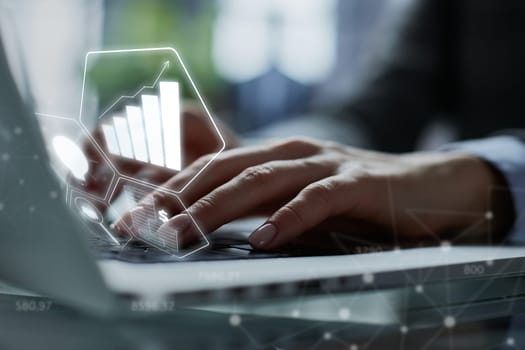 man's hands typing on laptop keyboard in interior