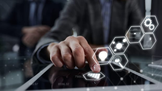 close up. businessman pressing his finger on the screen of the digital tablet