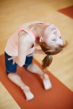 Shes a yoga pro. a woman doing a backbend during a yoga workout