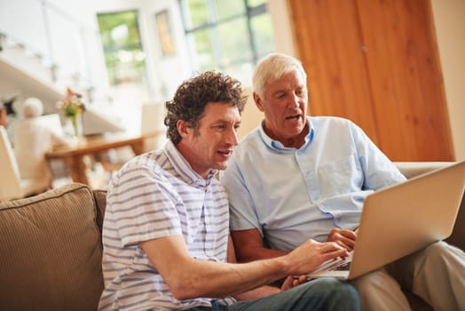 Explaining technology basics to his dad. a man and his father using a laptop indoors