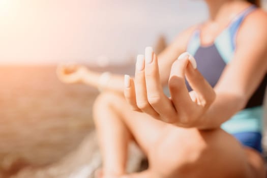 Woman sea yoga. Back view of free calm happy satisfied woman with long hair standing on top rock with yoga position against of sky by the sea. Healthy lifestyle outdoors in nature, fitness concept.