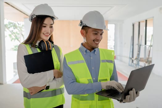 multi ethnic engineer brainstorming and measuring for cost estimating on blueprint and floor plan drawings about design architectural and engineering for houses and buildings.