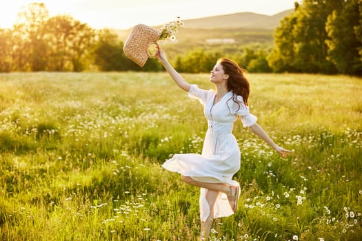 a woman in a light, long dress jumps in a field with a basket of daisies in her hands. High quality photo