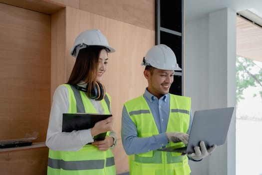 multi ethnic engineer brainstorming and measuring for cost estimating on blueprint and floor plan drawings about design architectural and engineering for houses and buildings.