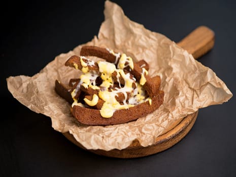 wide selection of snacks for beer - cheese, croutons - on parchment top view