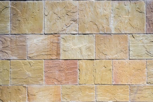 Background from a wall made of brown natural stones