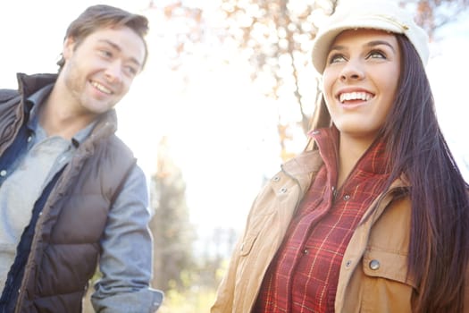 Enjoying the beauty of nature. A happy young couple spending time together out in nature