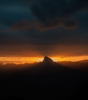 Impressive orange horizon with storm clouds, rays of light and space for text