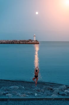 Woman The full moon rises to the lighthouse, the lunar path along the sea leads to the woman