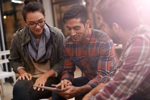 Technology brings people together. young people using a digital tablet in a coffee shop