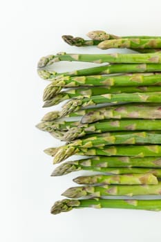 Fresh sliced asparagus plant on white background. Top view. Vegan healthy food