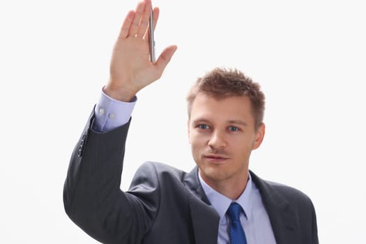 A businessman holds a hand up with a pen at a seminar asks him to give a floor to speak out to make a comment to talk with a lecturer a note on a statement.