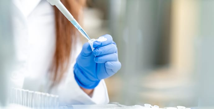 pipetting a chemical sample into research flasks. High quality photo