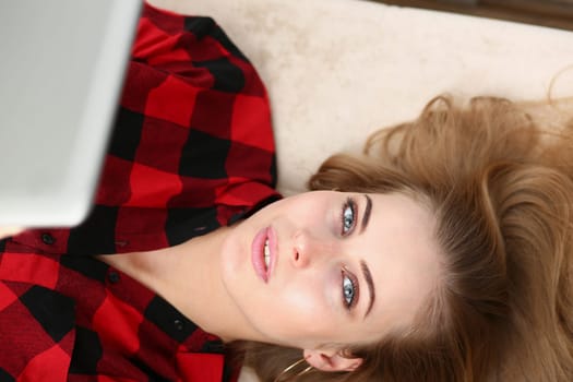 young pretty woman lie on sofa work on laptop free yime concept