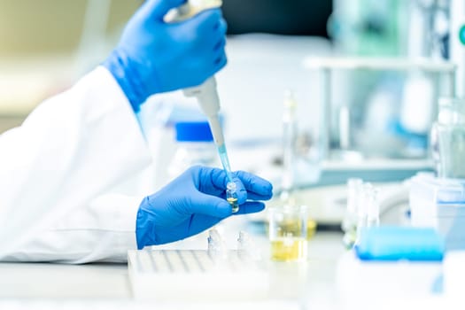 pipetting of chemical samples during research in a biochemical scientific laboratory. High quality photo