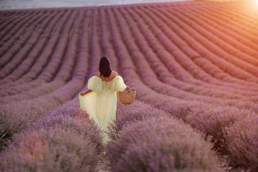 Woman lavender field. Lavender field happy woman in yellow dress in lavender field summer time at sunset.