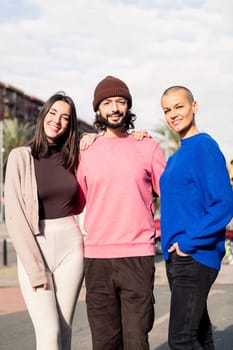 three joyful best friends smiling together looking at camera, concept of friendship and togetherness